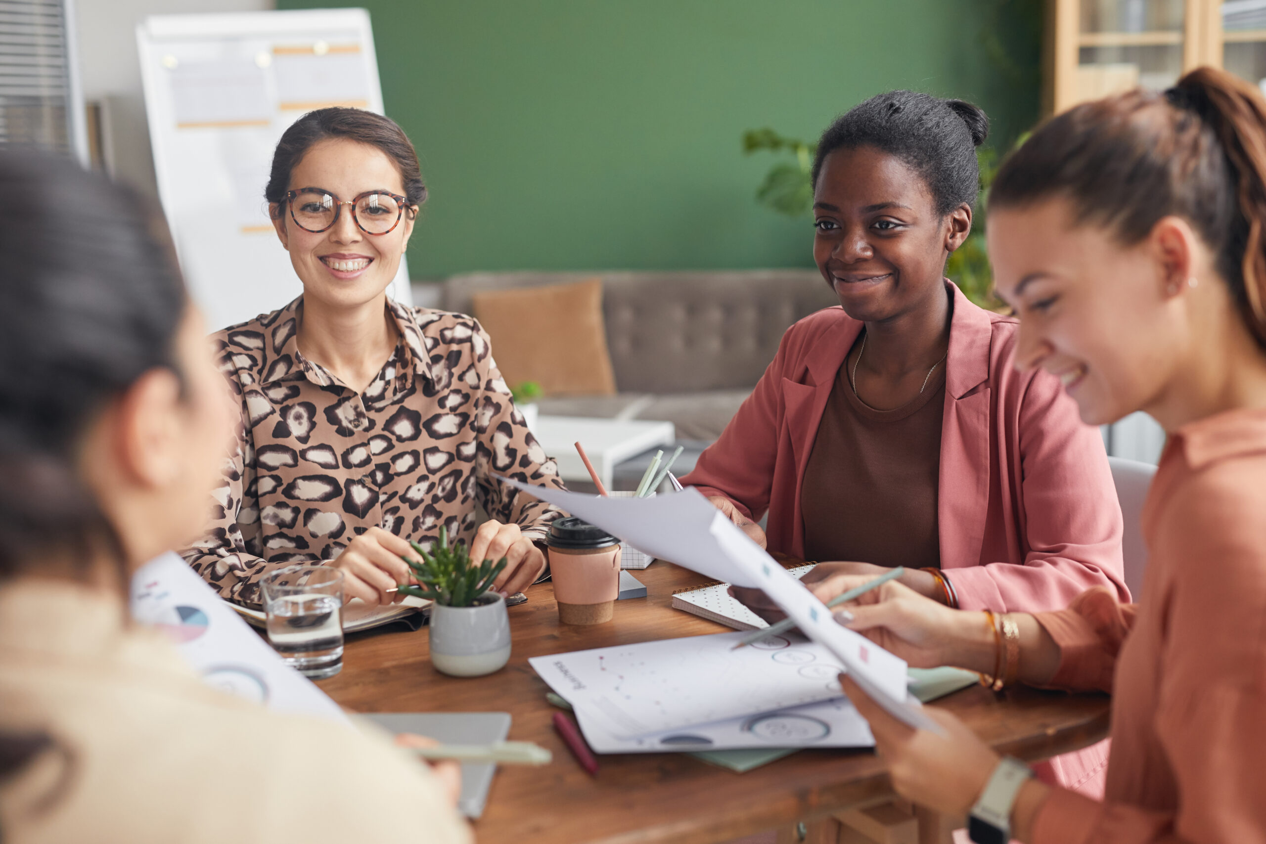 Four interns collaborating in a sales internship program.