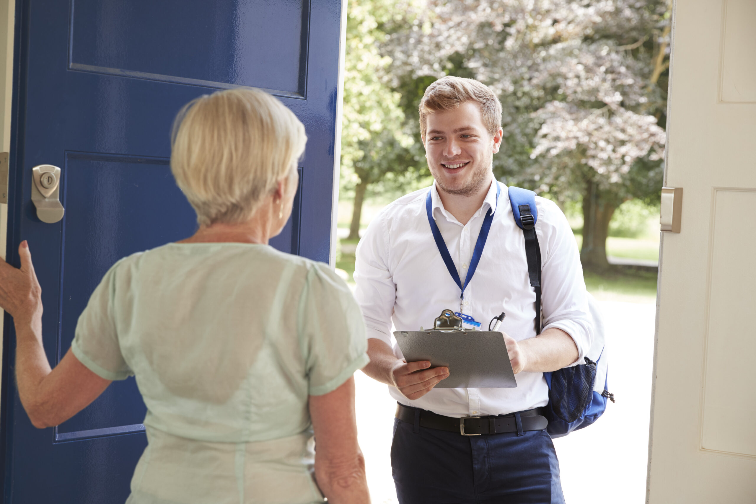 A sales rep talking to a customer during door-to-door sales.